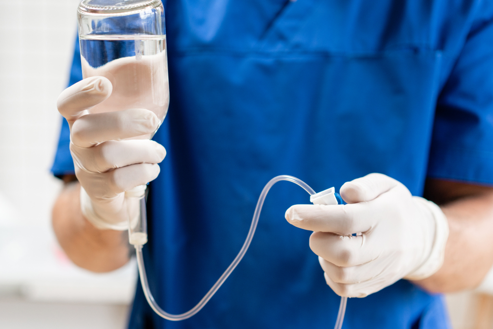 Doctor holding iv drip and infusion pump