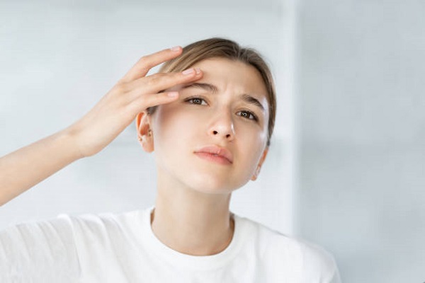female worrying of tightness of her skin after chemical peel treatment