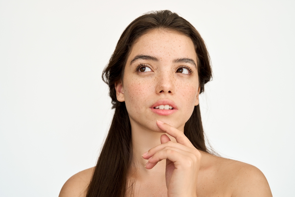 Young woman considering ProFractional laser vs. traditional laser resurfacing treatments for skin improvement