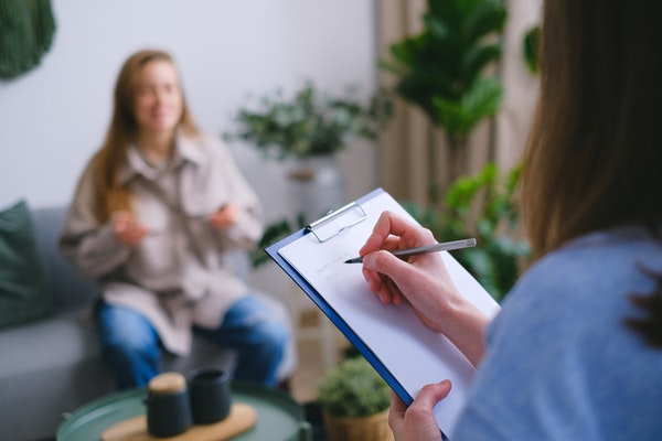 practitioner taking notes before procedure for PRP breast booster