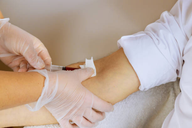 Provider draw blood in the arm of the patient for preparation in PRP Breast Booster