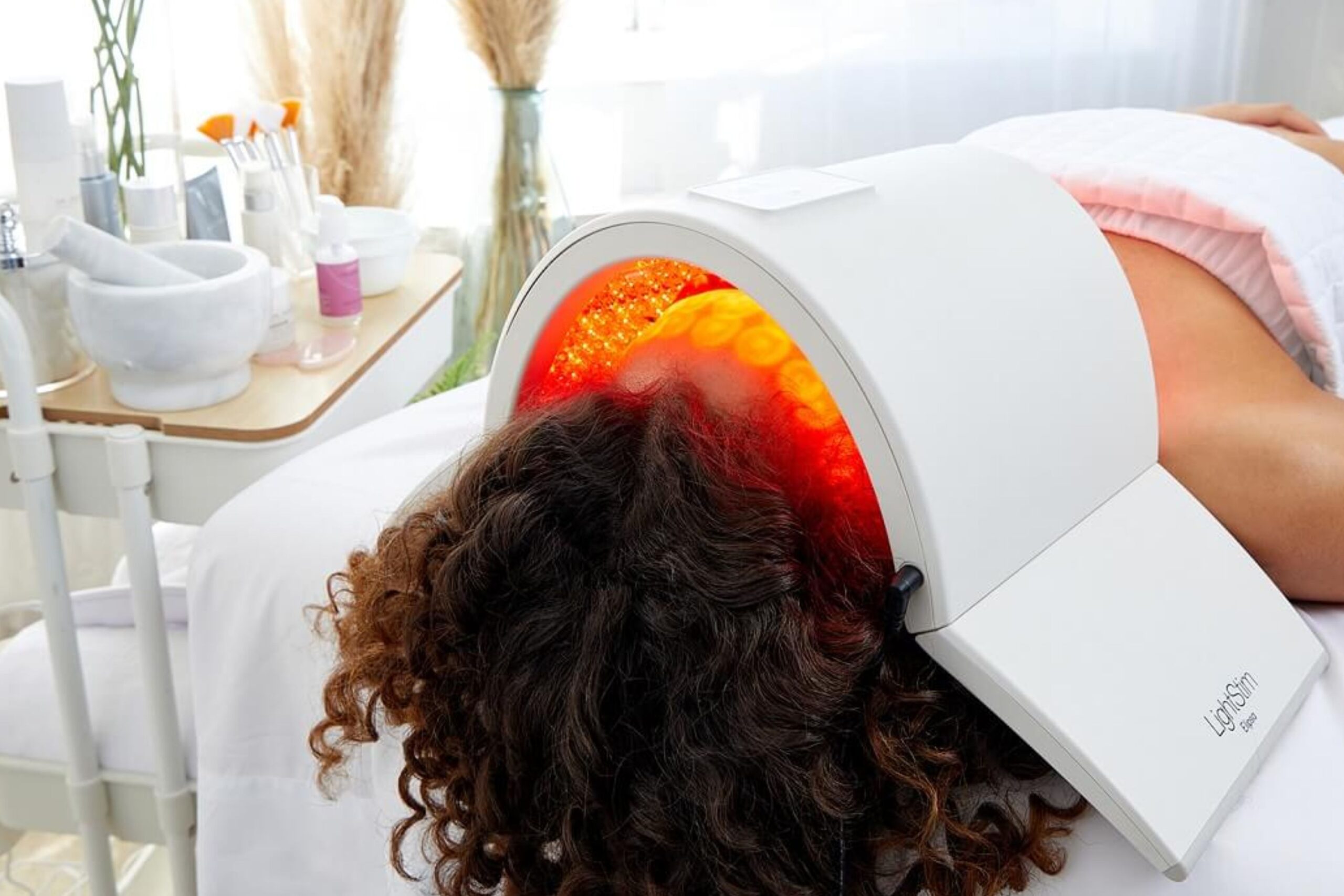 Close-up of a patient undergoing LED LightStim therapy for scalp and hair health, highlighting the treatment process