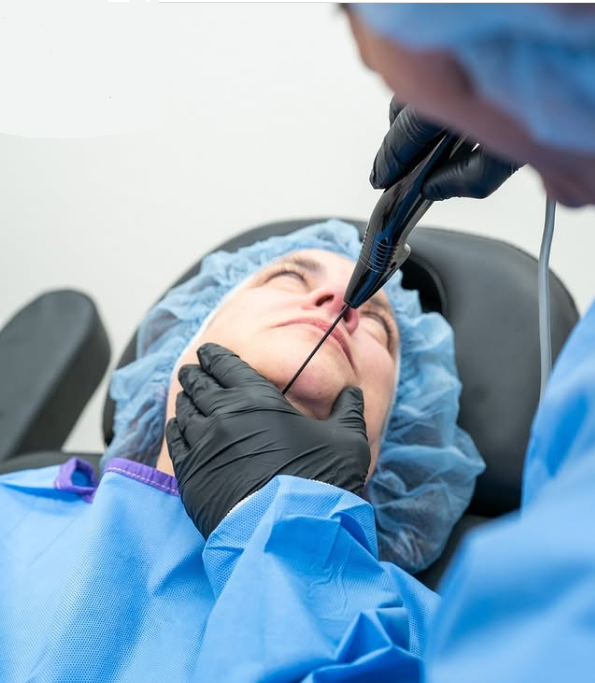 Cosmetologist performing Quantum RF InMode procedure on a patient's face for skin tightening.