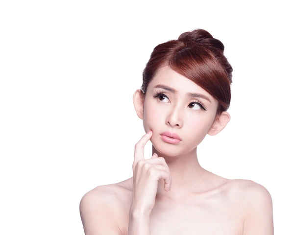 Young woman contemplating if she is a good candidate for Juvederm Ultra XC treatment to enhance facial volume and smooth skin