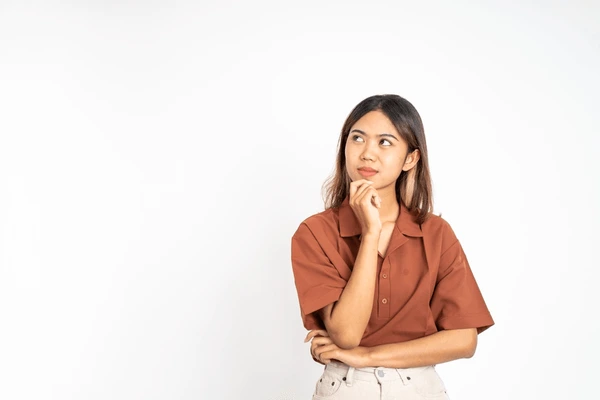 Young woman thinking about Restylane Kysse treatment for lip enhancement, considering its natural-looking results