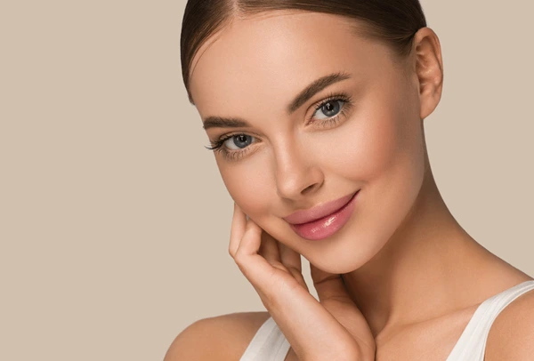 Smiling woman showcasing glowing skin after Xeomin treatment, emphasizing effective aftercare and recovery results
