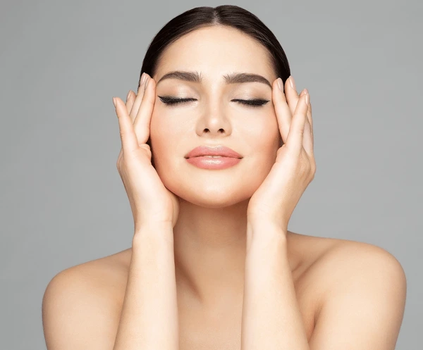 Woman with glowing skin post Restylane Defyne injection, showcasing smooth recovery and aftercare benefits for radiant results