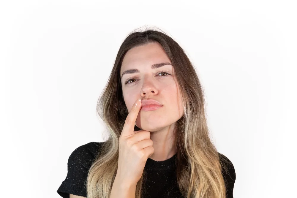 Thoughtful woman considering if she is a good candidate for FormaV vaginal rejuvenation treatment, evaluating her needs and eligibility for the procedure.