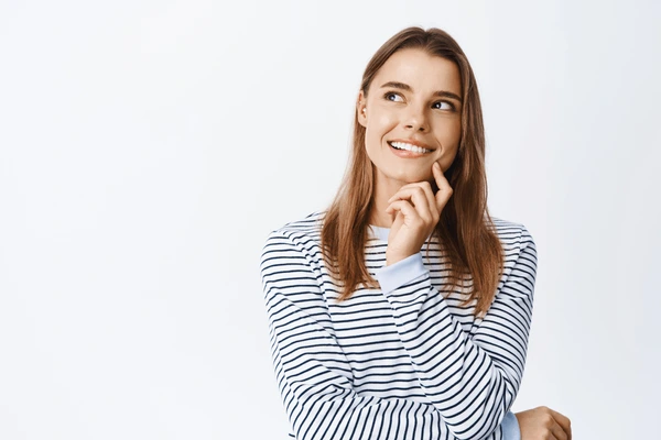 Smiling young woman contemplating candidacy for Juvederm Vollure XC filler treatment