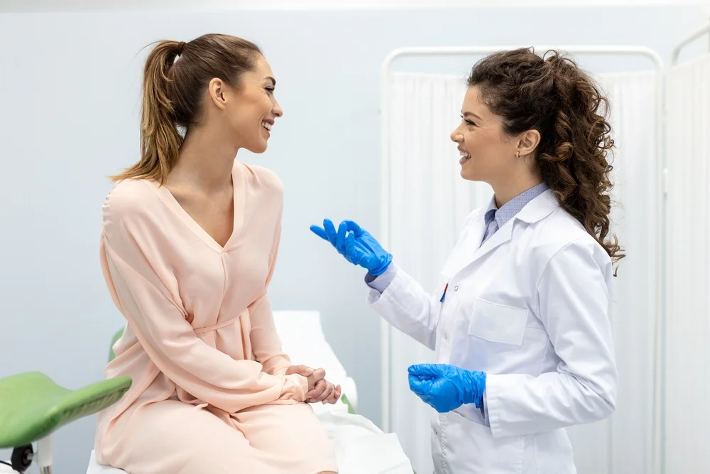 Doctor consulting a patient before VTone procedure, discussing the non-surgical pelvic floor treatment for improved muscle tone and bladder control.