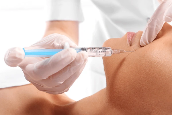 Close-up of Restylane Contour injection during treatment, targeting facial areas to enhance volume and reduce wrinkles