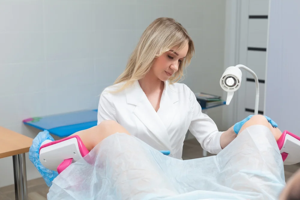 Doctor performing VTone procedure, a non-surgical pelvic floor treatment using electrical muscle stimulation to improve vaginal tone and bladder control.