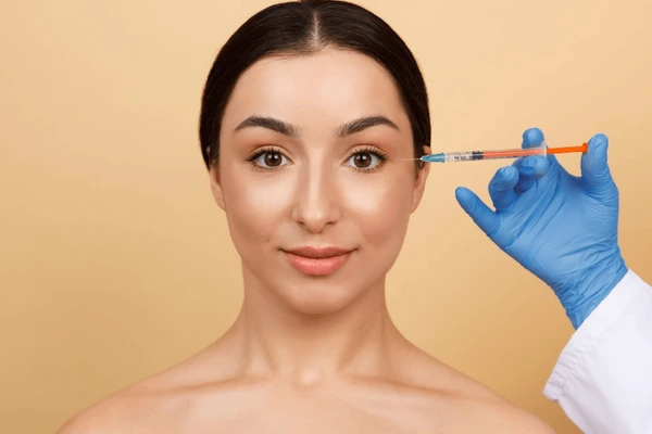 dysport-crows-line-filler-treatment Woman receiving Dysport injection for crow's lines to smooth wrinkles around the eyes
