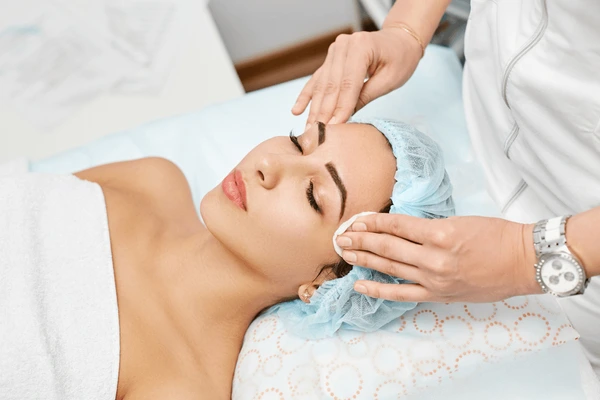 Patient undergoing skin cleansing during preparation for Dysport treatment