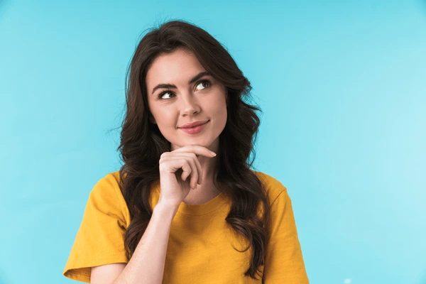 Smiling woman thoughtfully considering if she is a good candidate for Dysport treatment
