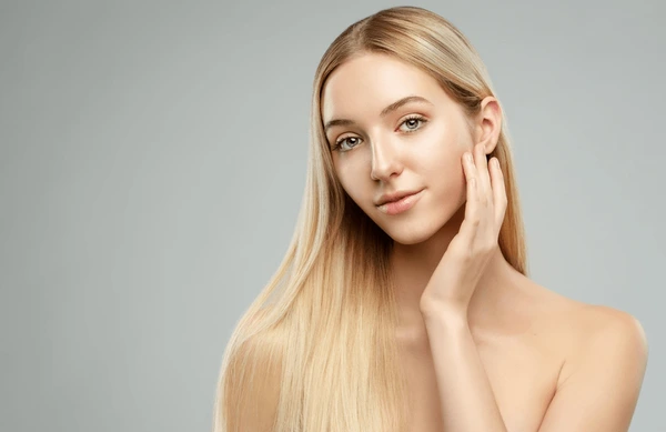 Beautiful woman showcasing results after Juvederm Ultra XC injection with smooth skin