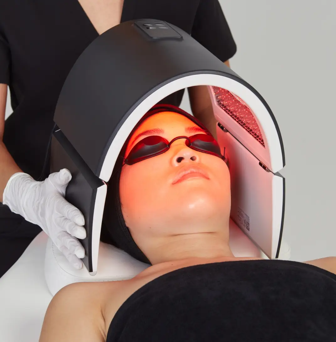 Patient undergoing LED LightStim therapy session with red light treatment for skin rejuvenation and healing benefits
