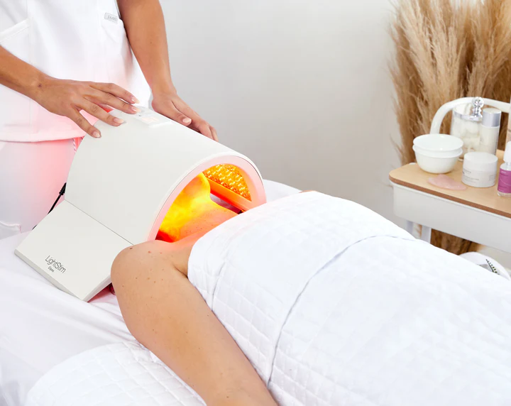 led-lightstim-therapy-treatment-device-session LED LightStim therapy device used in a skincare treatment session to rejuvenate skin and improve overall appearance.
