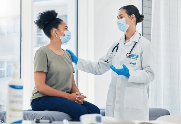 Doctor consulting patient before Morpheus8 treatment, discussing preparation steps for safe and effective skin tightening