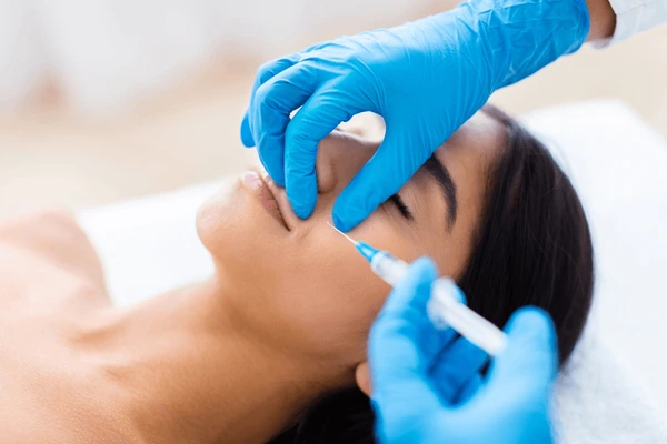 Professional applying Juvederm Vollure XC filler for nasolabial folds to reduce wrinkles and restore youthful appearance