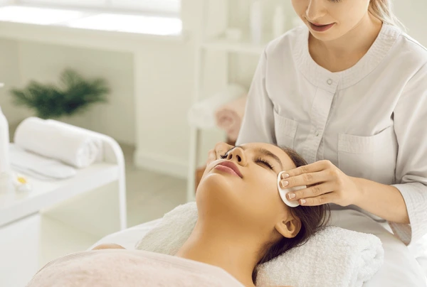 Patient receiving face cleansing as preparation for Sculptra treatment, ensuring optimal results for non-surgical facial rejuvenation