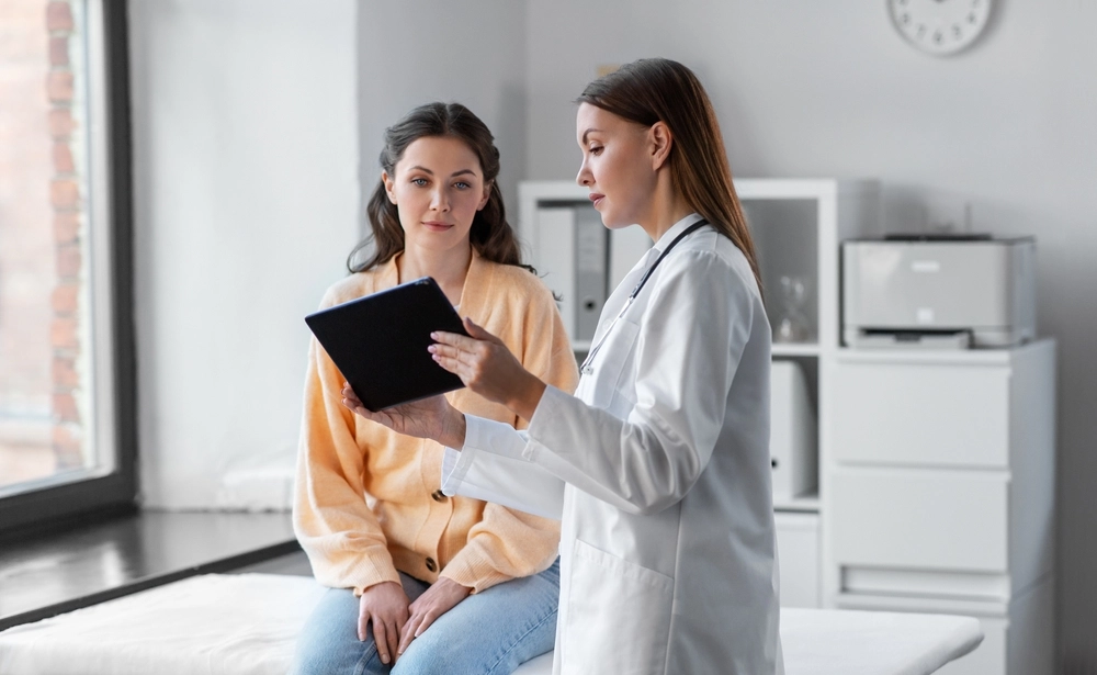 Patient consulting with a cosmetic professional to determine candidacy for Sculptra injection treatment.